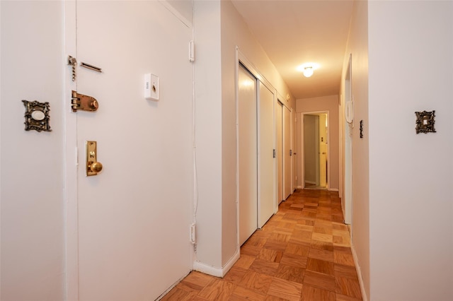 corridor with light parquet floors