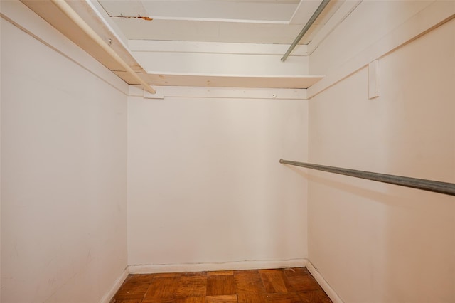 walk in closet featuring parquet floors