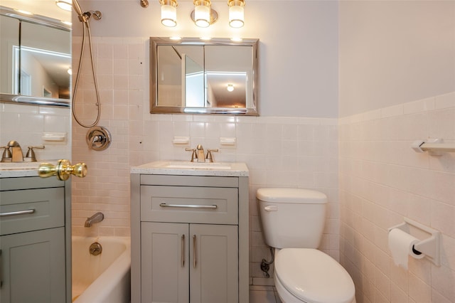 full bathroom with vanity, toilet, and tile walls