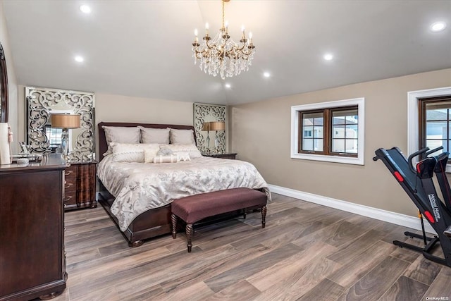 bedroom with dark hardwood / wood-style flooring and an inviting chandelier