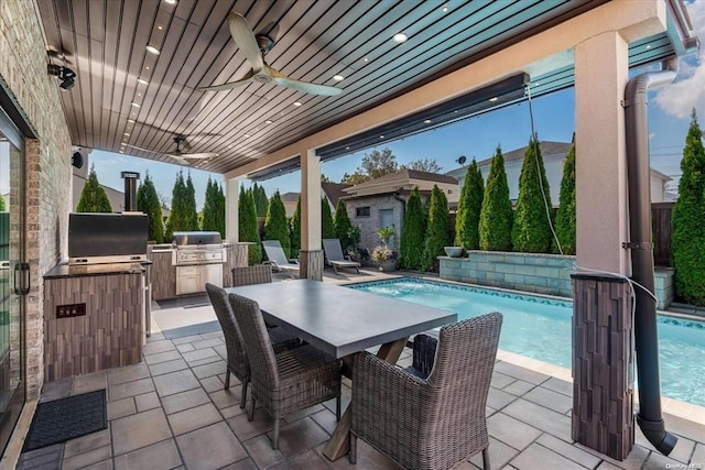 view of patio with ceiling fan, area for grilling, exterior kitchen, and exterior bar