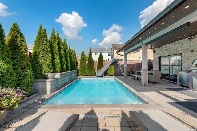 view of pool featuring a patio area and a water slide