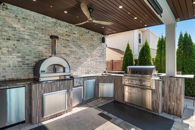 view of patio / terrace with ceiling fan, area for grilling, exterior kitchen, and sink