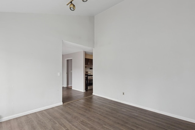 unfurnished room featuring dark hardwood / wood-style floors and high vaulted ceiling