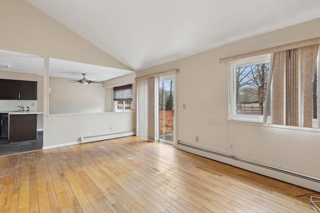 unfurnished living room with ceiling fan, light hardwood / wood-style floors, vaulted ceiling, and a baseboard radiator