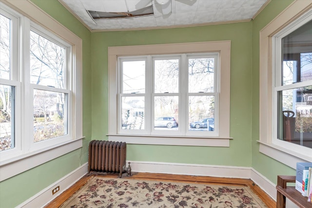 sunroom with radiator heating unit and a healthy amount of sunlight