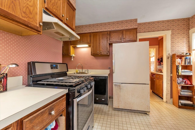 kitchen featuring gas range, black dishwasher, white fridge, and sink