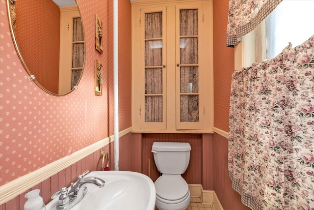 bathroom with tile patterned floors, sink, and toilet