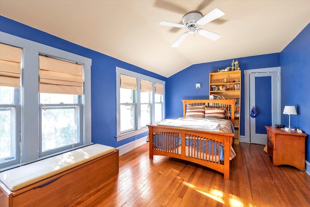 bedroom featuring hardwood / wood-style floors, vaulted ceiling, and ceiling fan