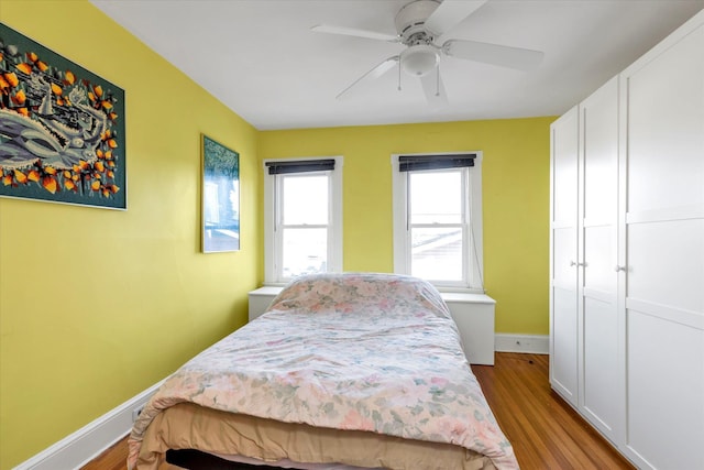 bedroom with ceiling fan and light hardwood / wood-style floors