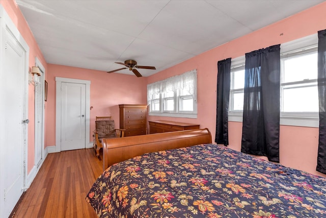 bedroom with ceiling fan and hardwood / wood-style flooring