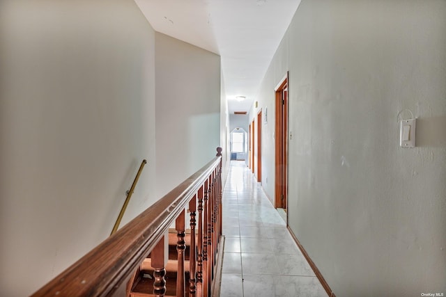 hall with light tile patterned floors