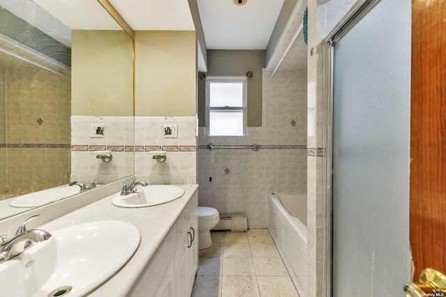 full bathroom with a baseboard heating unit, tile patterned floors, toilet, tile walls, and independent shower and bath