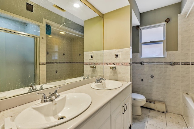 full bathroom with a baseboard heating unit, tile patterned floors, toilet, independent shower and bath, and tile walls