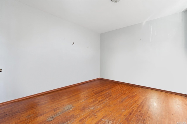 empty room with hardwood / wood-style flooring