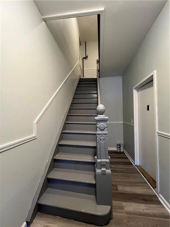 staircase featuring hardwood / wood-style floors