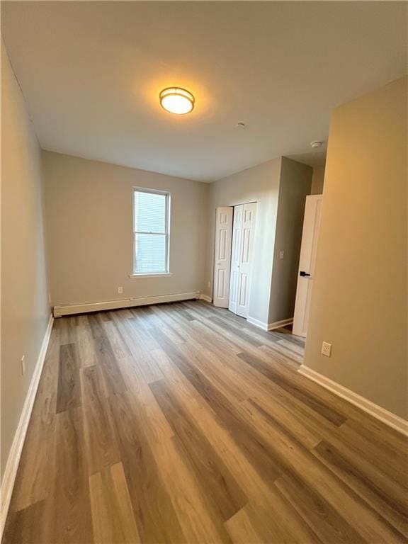 spare room with light hardwood / wood-style flooring