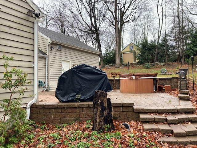 exterior space featuring a patio area and a hot tub