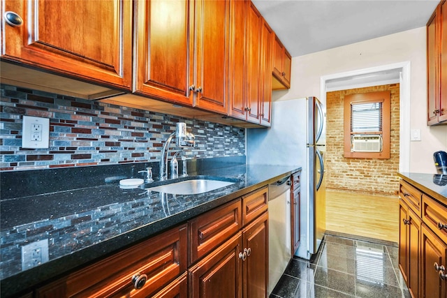 kitchen with sink, stainless steel dishwasher, dark hardwood / wood-style floors, dark stone countertops, and cooling unit