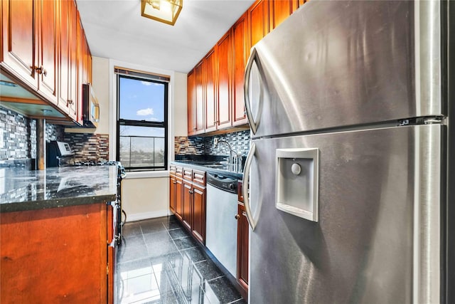 kitchen featuring decorative backsplash, sink, dark stone counters, and appliances with stainless steel finishes