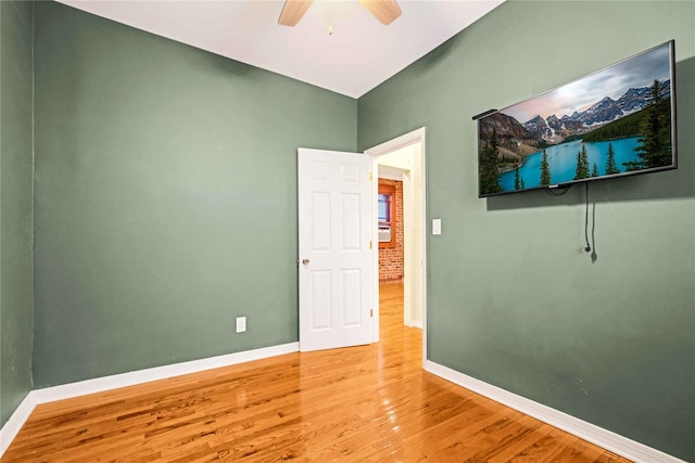 empty room featuring ceiling fan and hardwood / wood-style floors