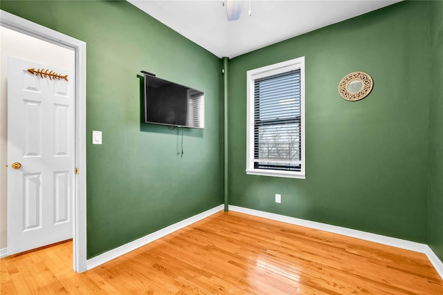 empty room with ceiling fan and light wood-type flooring