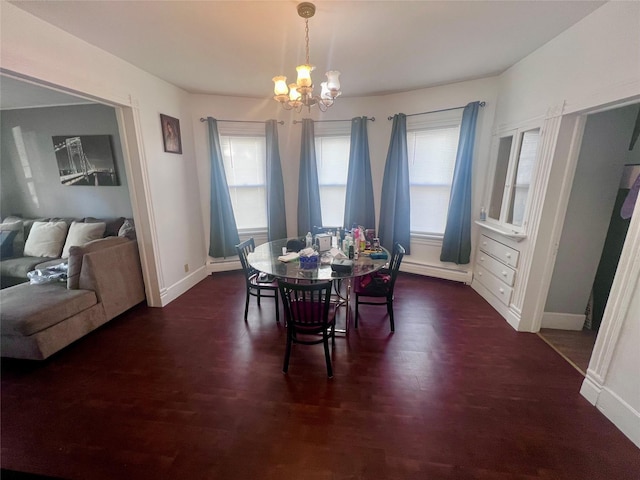 dining space with a notable chandelier, dark hardwood / wood-style floors, and baseboard heating