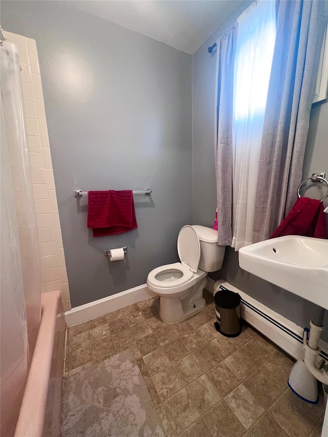 full bathroom with toilet, shower / bath combo with shower curtain, and sink