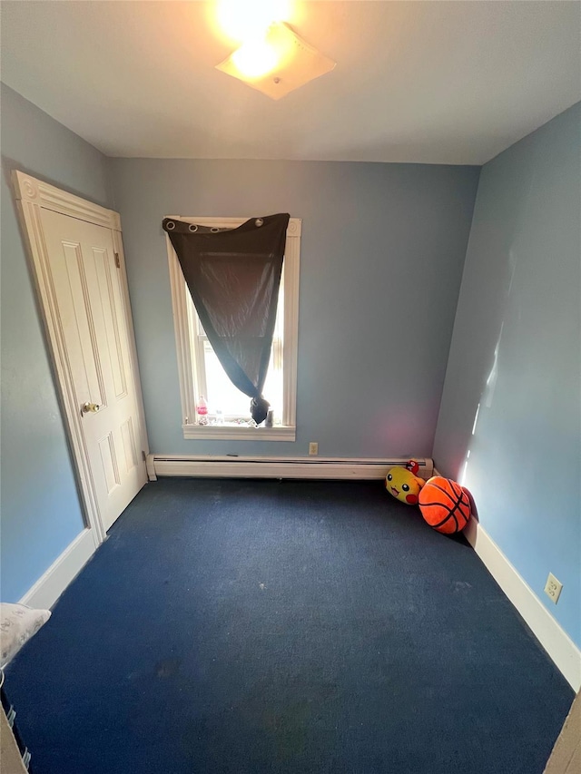 empty room with carpet flooring and a baseboard radiator