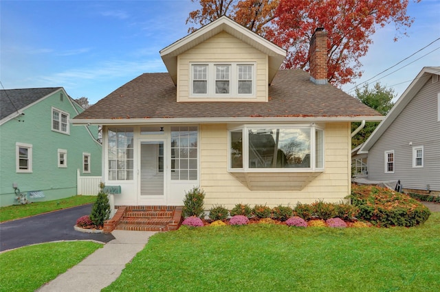 bungalow with a front lawn