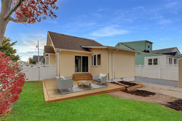 rear view of house featuring a lawn, an outdoor living space, and a deck