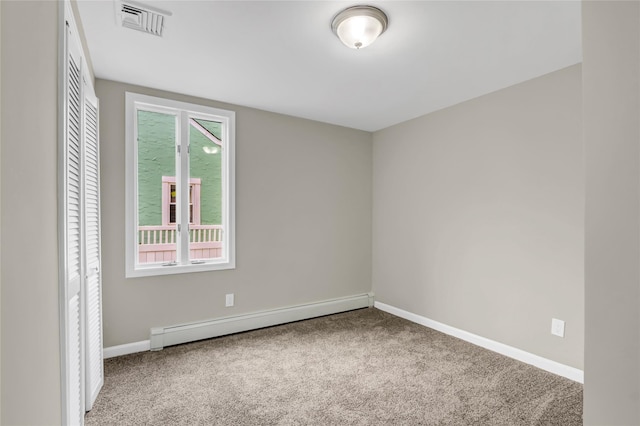 carpeted spare room with baseboard heating