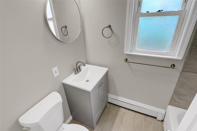 bathroom with plenty of natural light, toilet, baseboard heating, and vanity