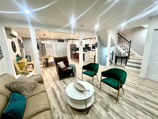 living room with light wood-type flooring and an AC wall unit