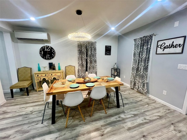 dining space with hardwood / wood-style flooring, a wall unit AC, and a chandelier