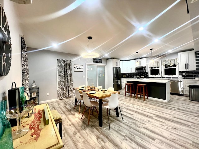 dining room featuring light hardwood / wood-style floors and sink