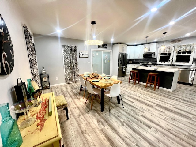 dining area featuring light wood-type flooring