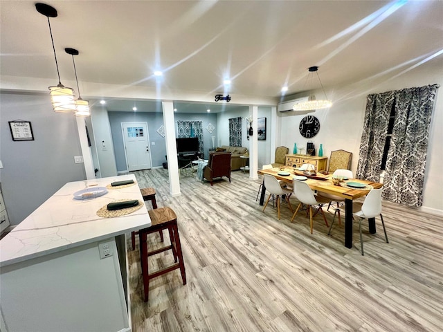 dining room with light hardwood / wood-style flooring and a wall mounted air conditioner