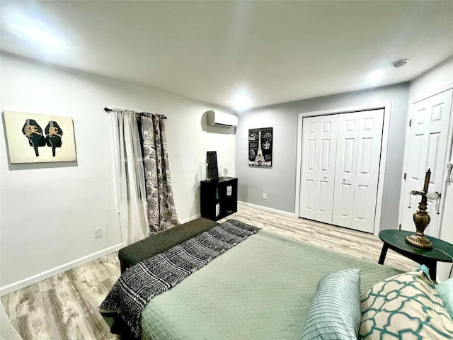 bedroom featuring light wood-type flooring and a wall unit AC