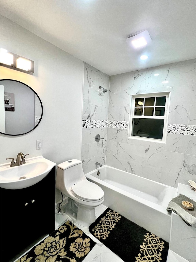 full bathroom with vanity, tiled shower / bath combo, and toilet