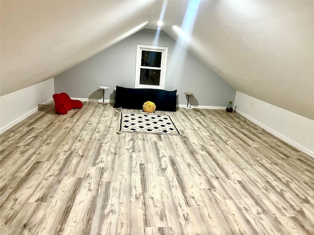 bonus room with light hardwood / wood-style flooring and vaulted ceiling