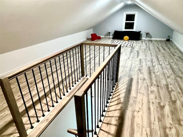 bonus room with hardwood / wood-style floors and vaulted ceiling