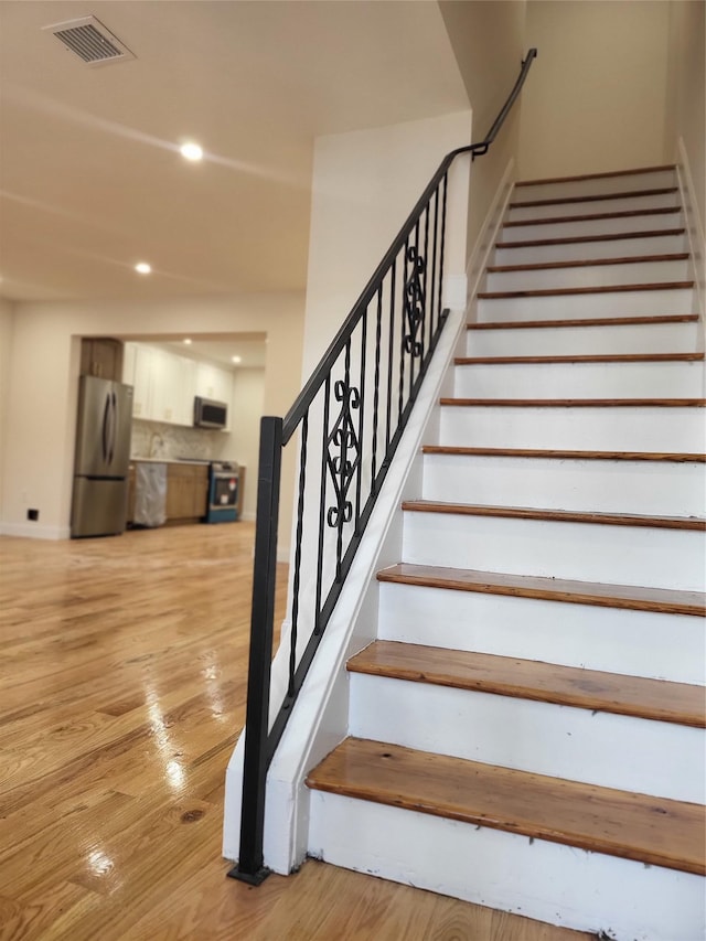 staircase featuring hardwood / wood-style floors