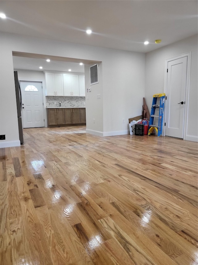 unfurnished living room featuring light hardwood / wood-style floors