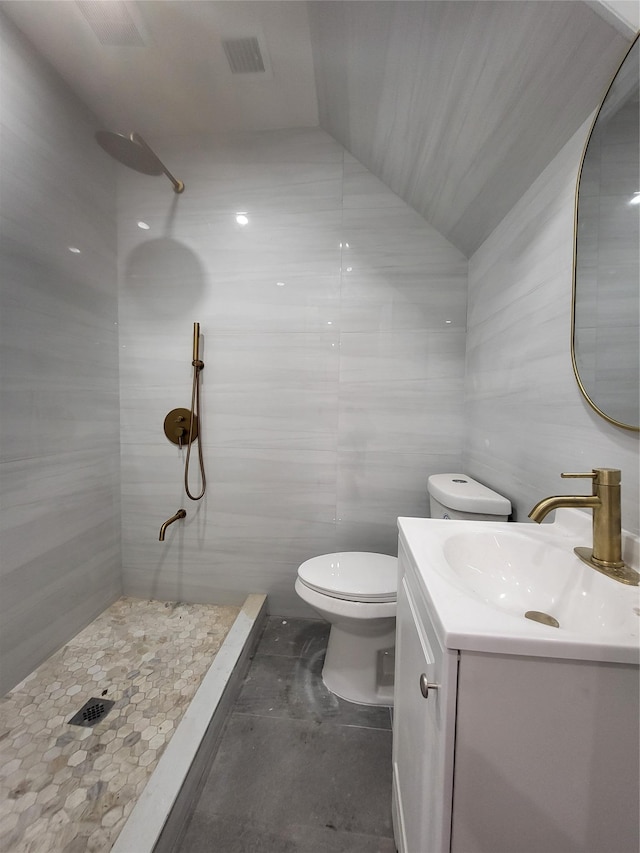 bathroom with walk in shower, vanity, vaulted ceiling, and toilet