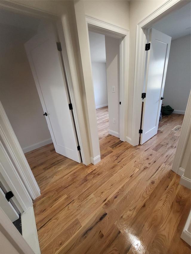 corridor featuring light hardwood / wood-style floors