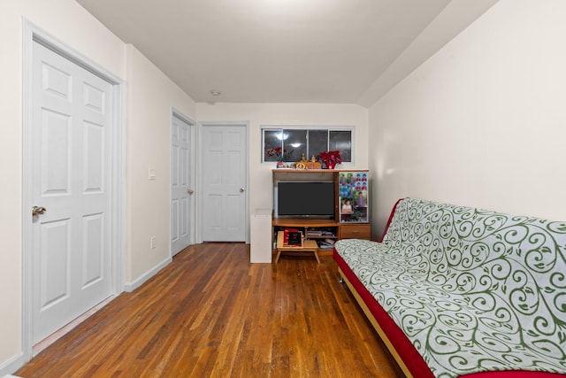 sitting room with dark wood-type flooring