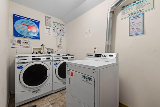 laundry room featuring washer and dryer and light tile patterned floors