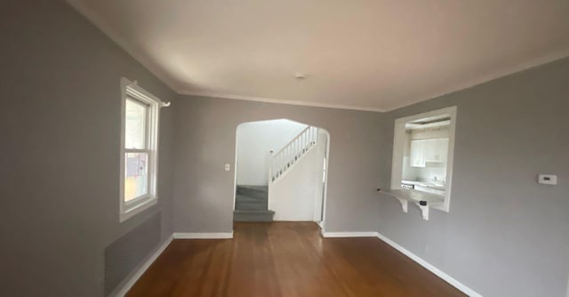 unfurnished room featuring hardwood / wood-style flooring and crown molding