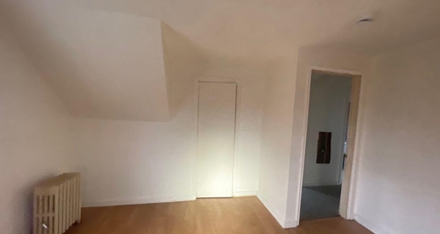 bonus room featuring radiator and light hardwood / wood-style flooring